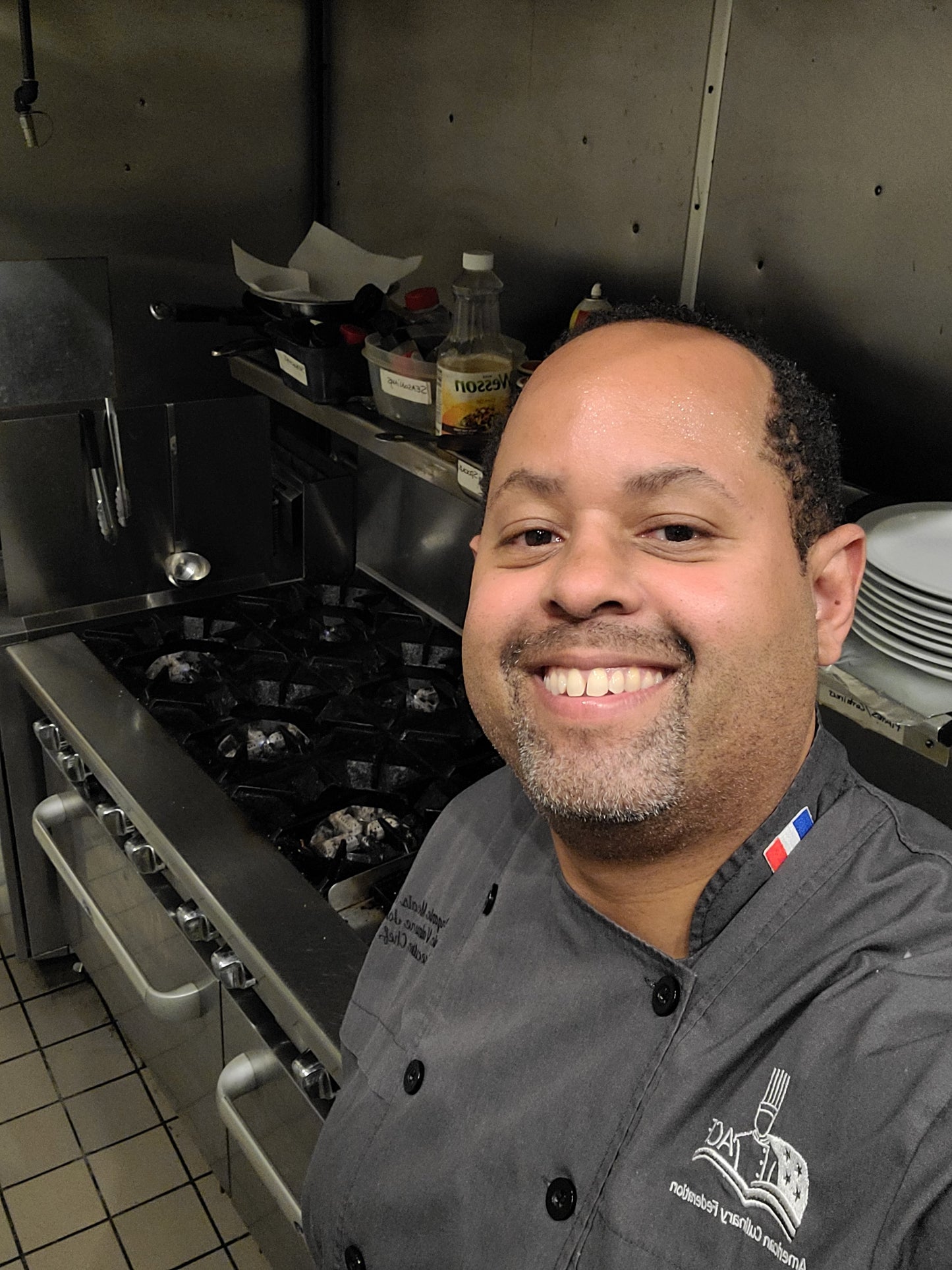 chef eric standing next to client gas stove