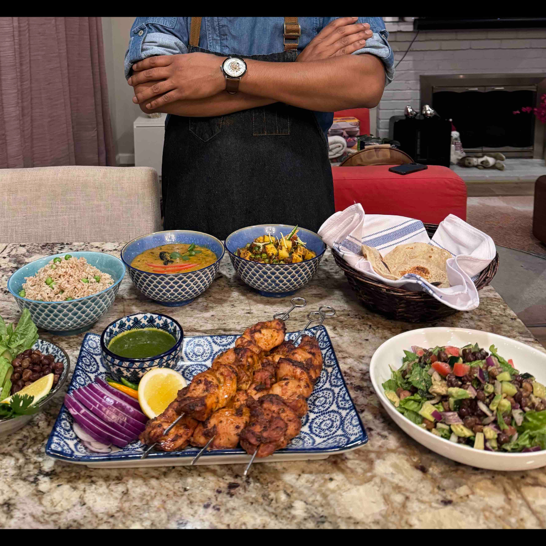 Indian Chef Standing Next to Meal Prep Done At A Client's Place